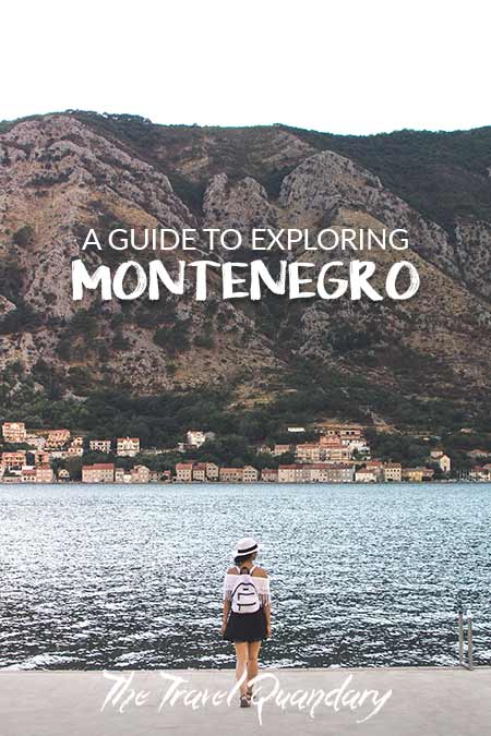 Unravelled A Guide To Exploring Montenegro A woman with a white hat and white backpack stands on the edge of the water overlooking the Bay of Kotor, Montenegro