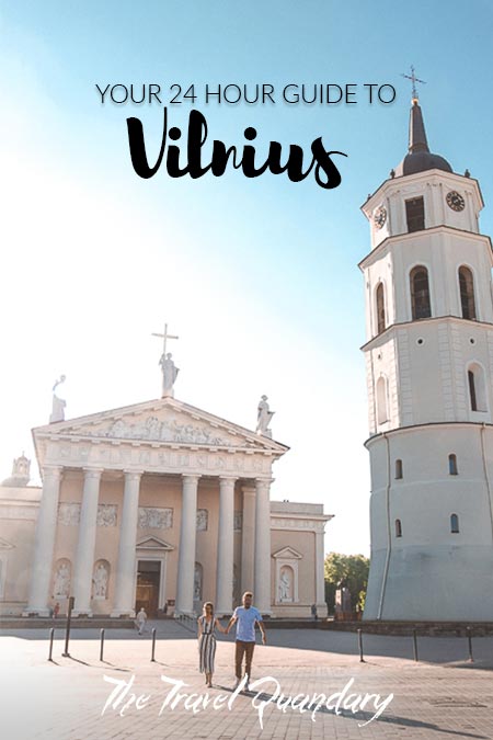 A couple walking in front of Vilnius Cathedral, Vilnius