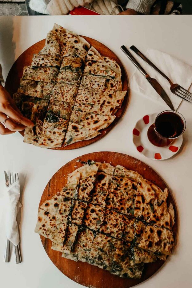 Two plates of piping hot gozleme and Turkish tea at Gözlemece. Istanbul, Türkiye