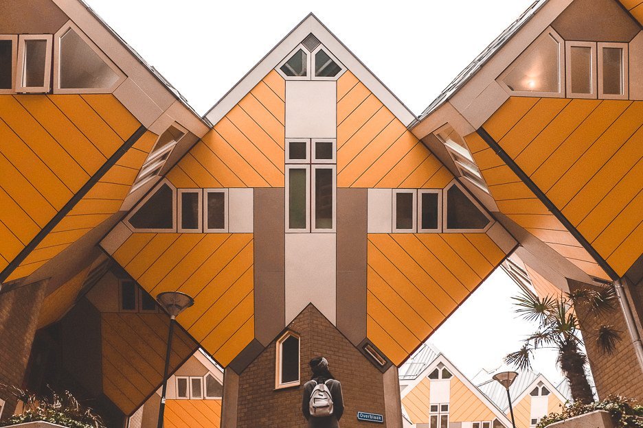 Jasmine looks up at the yellow cube houses in Rotterdam, The Netherlands