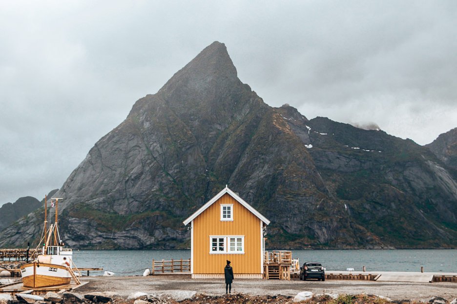Jasmine stands in front of the famed yellow house in the Lofoten Islands, Norway