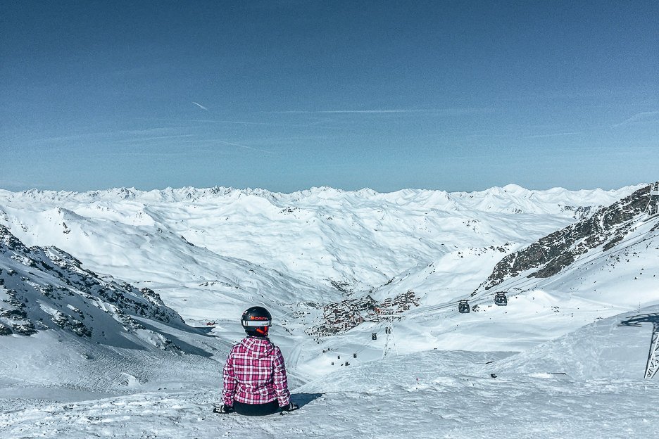Jasmine sits on the top of a ski run in Val Thorens, France