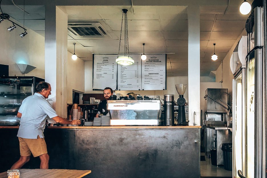 A barista serves a customer at Blackstar Coffee Roasters, Brisbane Coffee Guide