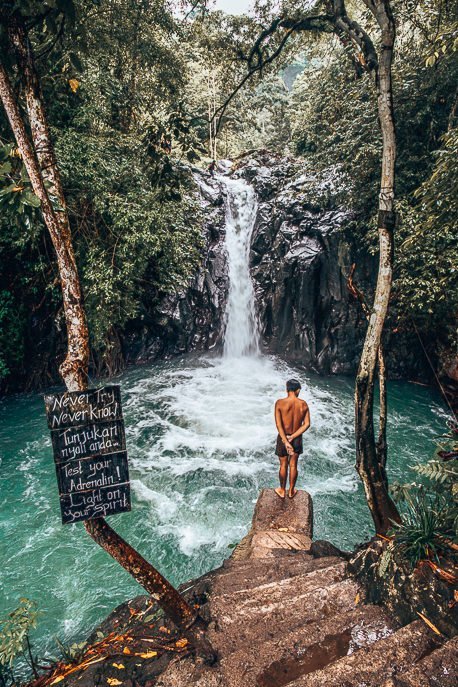 25 Incredible Photos Of Bali To Spark Your Wanderlust 9 P A local boy observes the water from the jumping platform at Kroya Waterfall, Bali Gallery