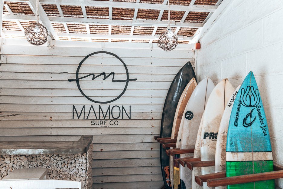A row of surfboards lined up for rental at Mamon Surf Shop, Siargao