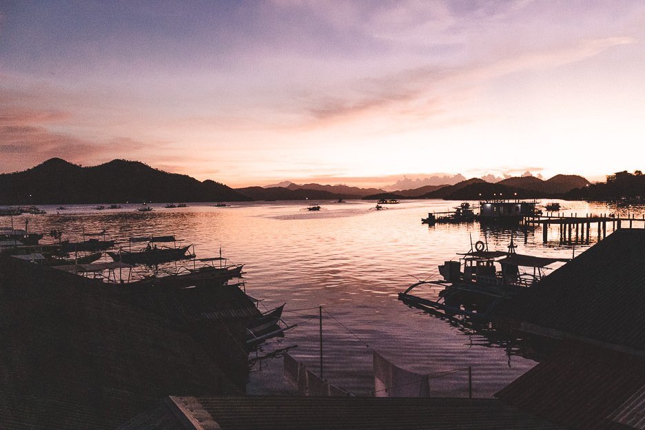 Beautiful pink and orange sunset over the harbour of Coron