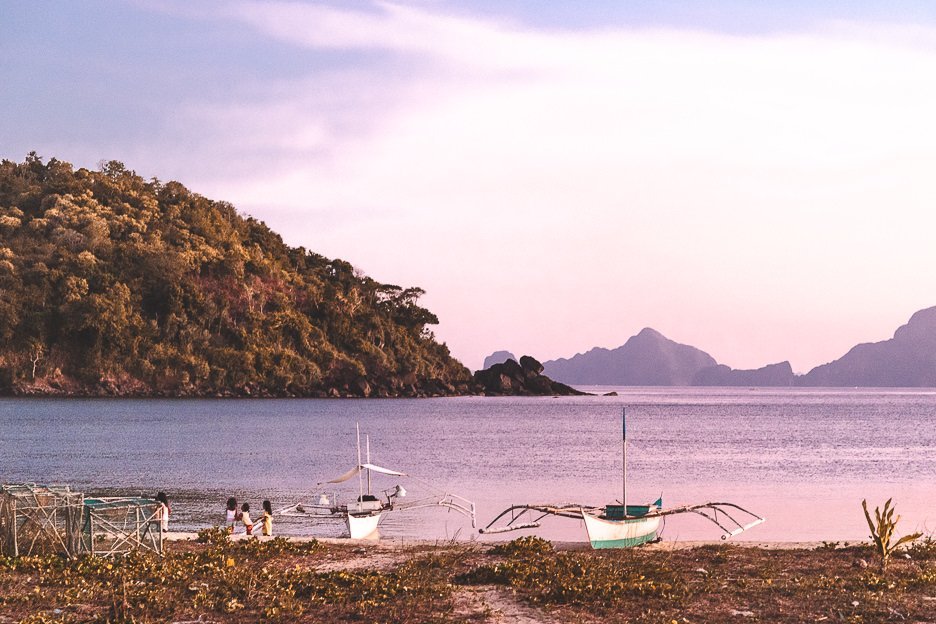 40 Stunning Photos That Will Make You Want To Visit The Philippines 33 L Young girls playing by the water next to two boats at Nacpan Beach during sunset, El Nido