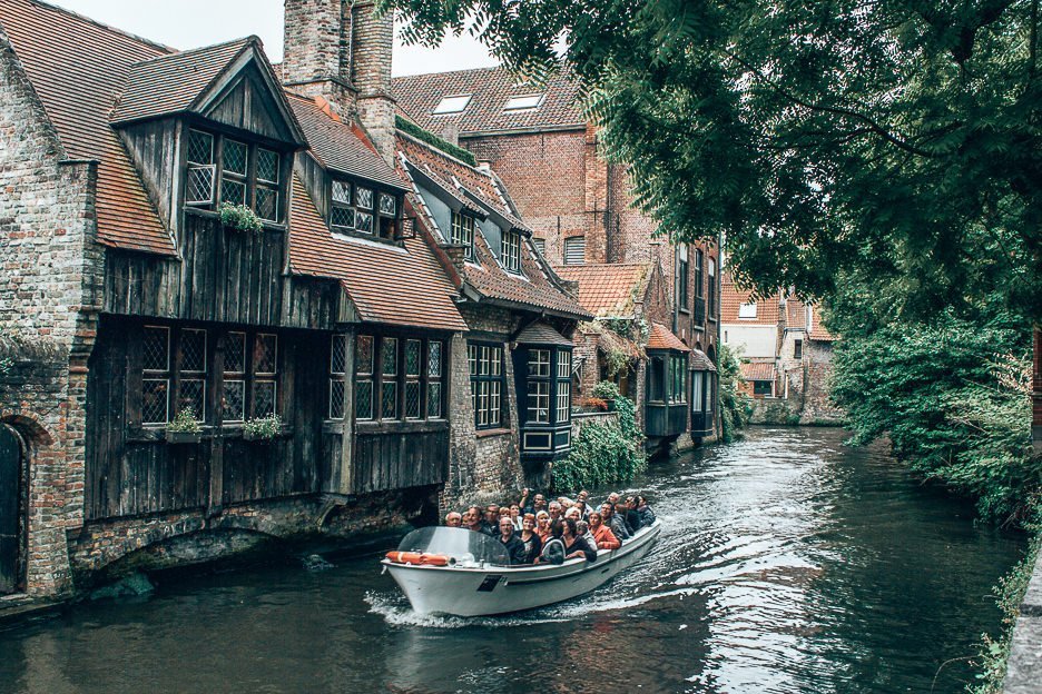 A Complete Guide To 24 Hours In Bruges 5 L A boat goes by on the canal in front of Bonifacius Bridge in Bruges, Belgium