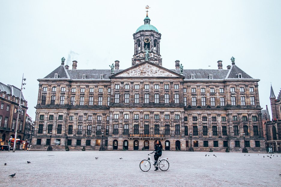 A Non Touristy Weekend Guide To Amsterdam 19 L Posing in front of the Royal Palace on a bicycle in Dam Square, Amsterdam