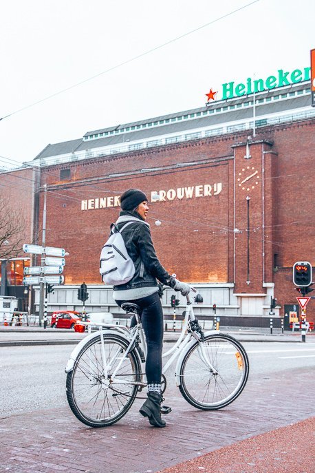 Riding a bicycle in front of the Heineken Brouwer'j, Amsterdam