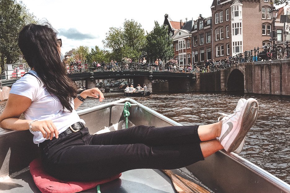 A Non Touristy Weekend Guide To Amsterdam 4 L Chilling in a motor boat cruising down the canals in Amsterdam