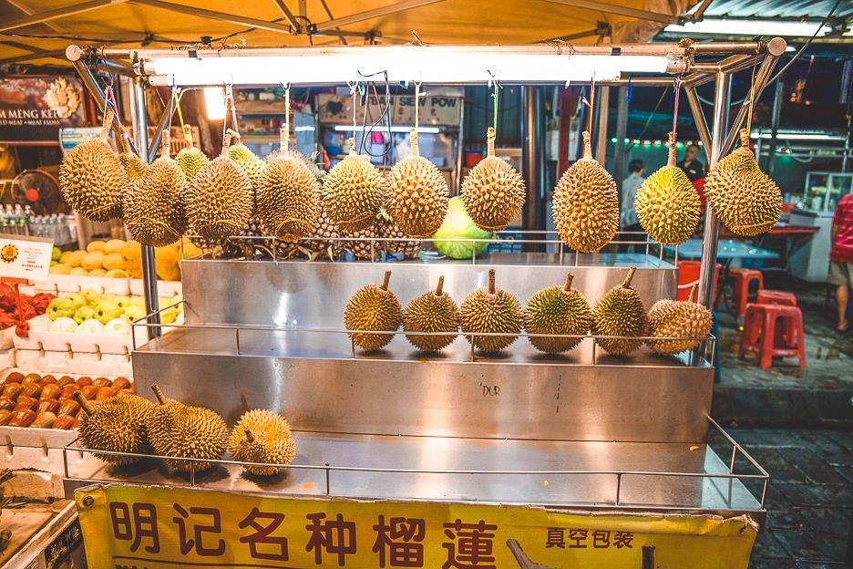 Hanging spiky durian fruit at Jalan Alor Street Food Market, Kuala Lumpur