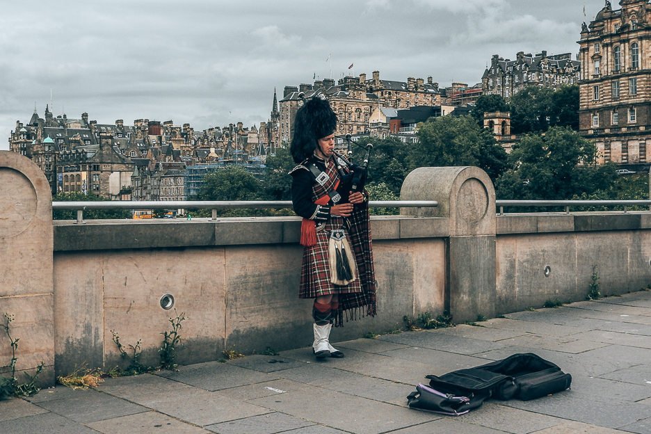 An Unmissable Guide To 48 Hours In Edinburgh 1 L A man in traditional Scottish dress plays the bagpipes, Edinburgh, Scotland