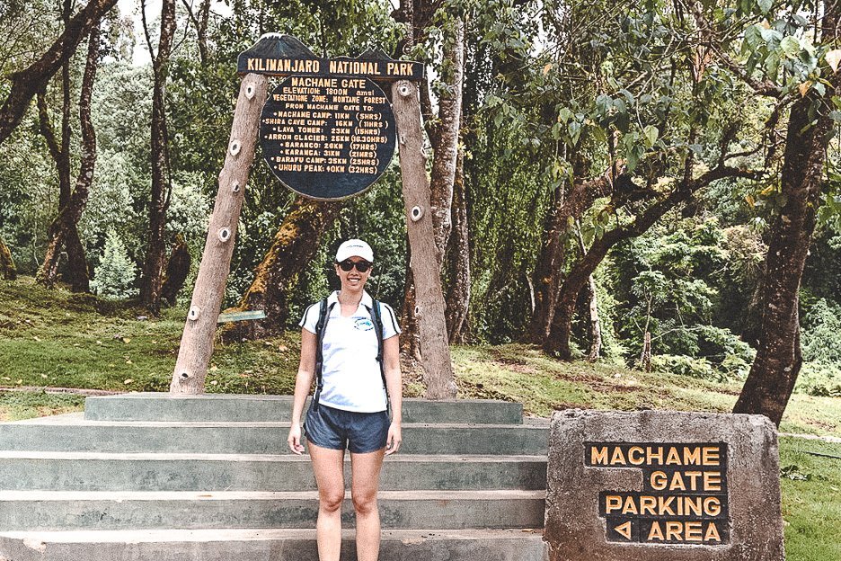 Jasmine stands at Machame Gate at the beginning of a 7 day hike of Mt Kilimanjaro