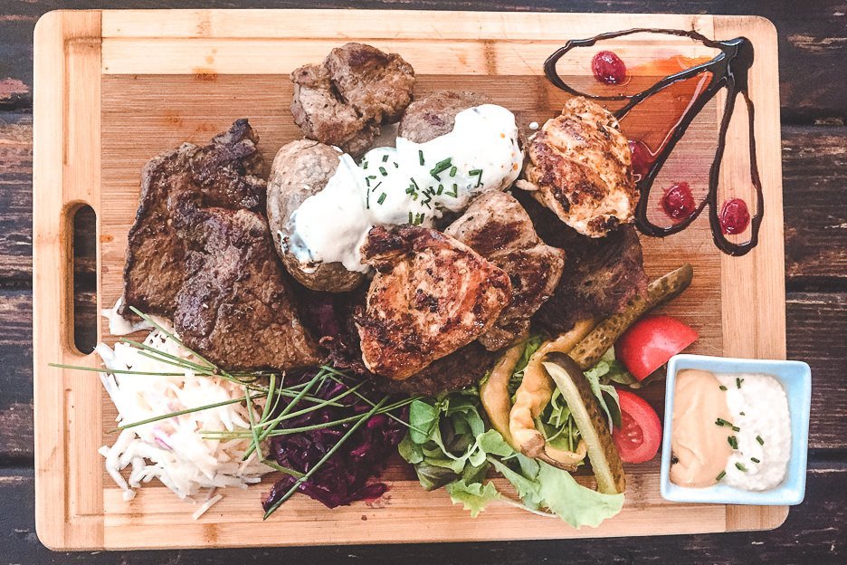 A meat platter with potatoes, salads and dips at Krčma v Šatlavské ulici, Cesky Krumlov
