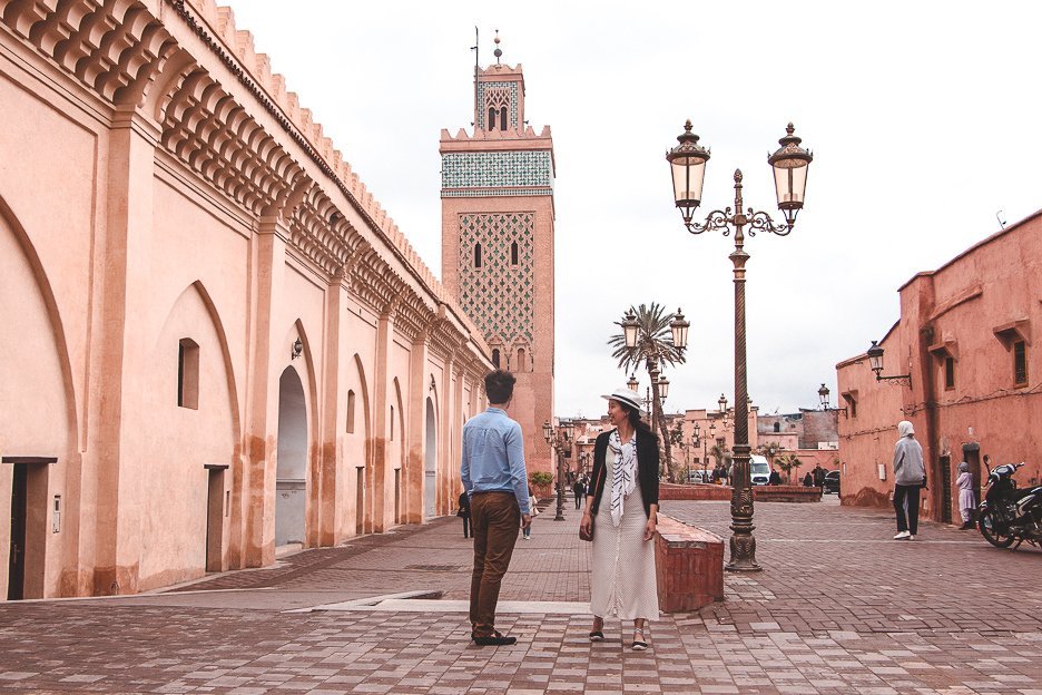 Morocco Travel Photography 35 Photos To Inspire You To Visit 14 L Jasmine and Bevan of The Travel Quandary stand outside Katoubia Mosque, Marrakech Morocco