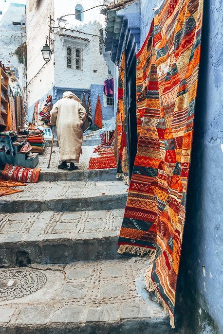 Morocco Travel Photography 35 Photos To Inspire You To Visit 31 P A berber man shuffles up some stairs in the city of Chefchaouen, Morocco