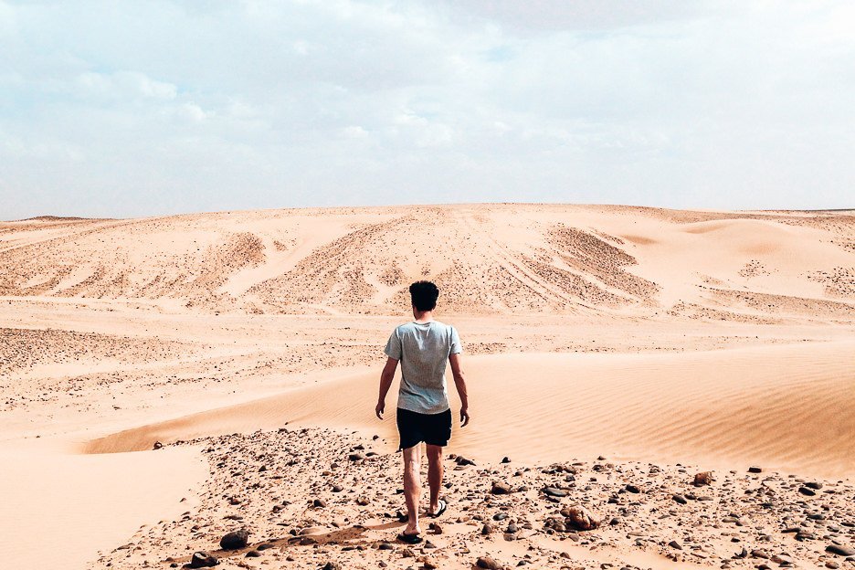 Morocco Travel Photography 35 Photos To Inspire You To Visit 5 L Bevan of the Travel Quandary walking in the Sahara Desert Morocco