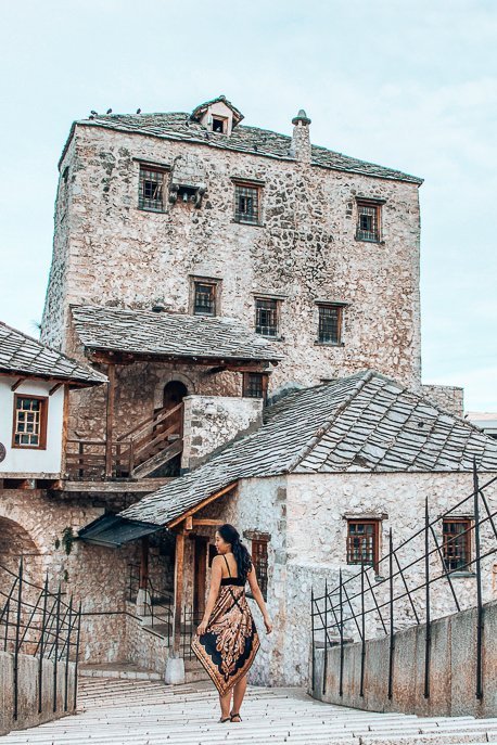 One Day In Mostar What To See Do 3 P A woman walks over the Stari Most in Mostar, Bosnia & Herzegovina