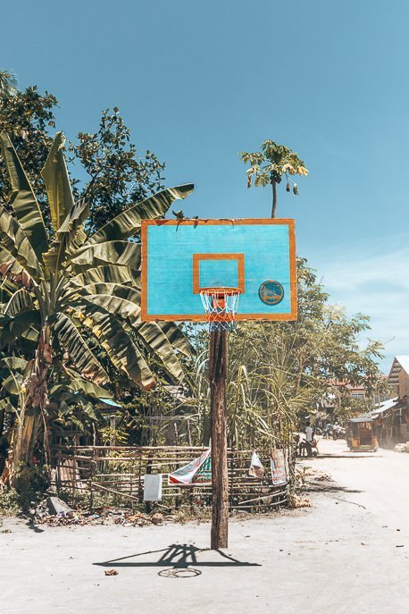 A lone basketball hoop on a sandy court, Siargao