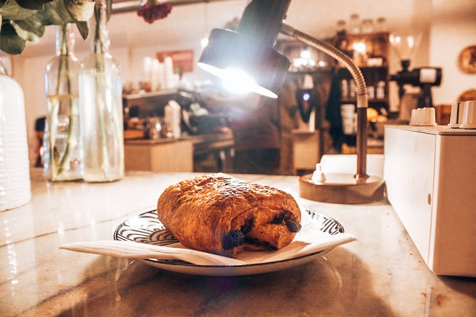 Chocolate croissant under lamplight at White Label Coffee