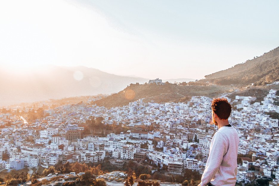Bevan of The Travel Quandary looks towards sunset over the city, Chefchaouen Morocco