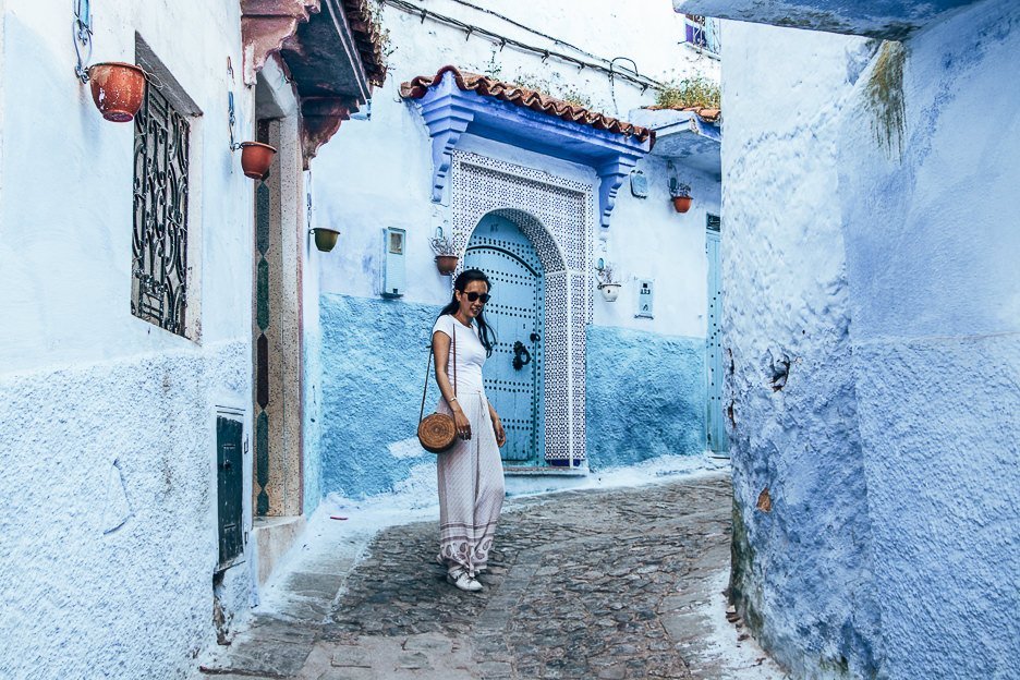 How many days in Chefchaouen | Woman dressed in white stands in a blue laneway in Chefchaouen Morocco