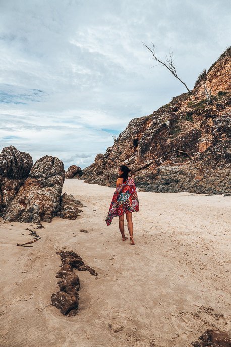 The Ultimate Beach Packing List 2 P A girl walks on the sand at the Pass in Byron Bay with the Bohemian Tesalate towel around her shoulders