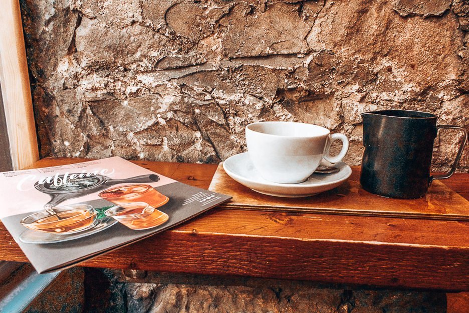 Filter coffee and magazine on a bench table at Brew Lab, Edinburgh