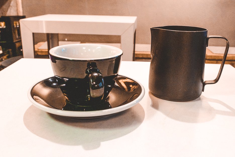 Filter coffee in black cup and saucer at The Barn, Berlin Germany