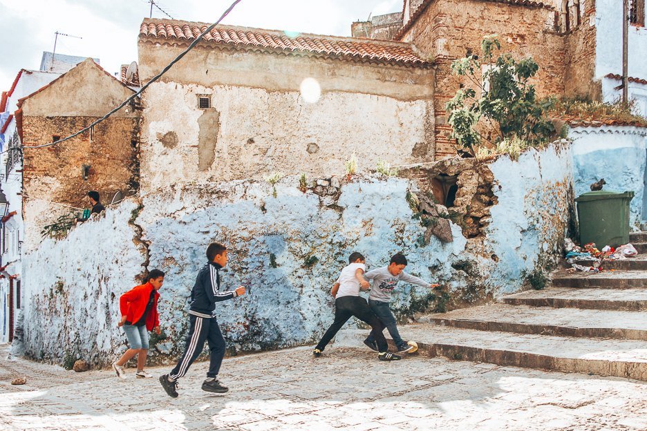 Children play football in the streets of Chefchaouen, Morocco