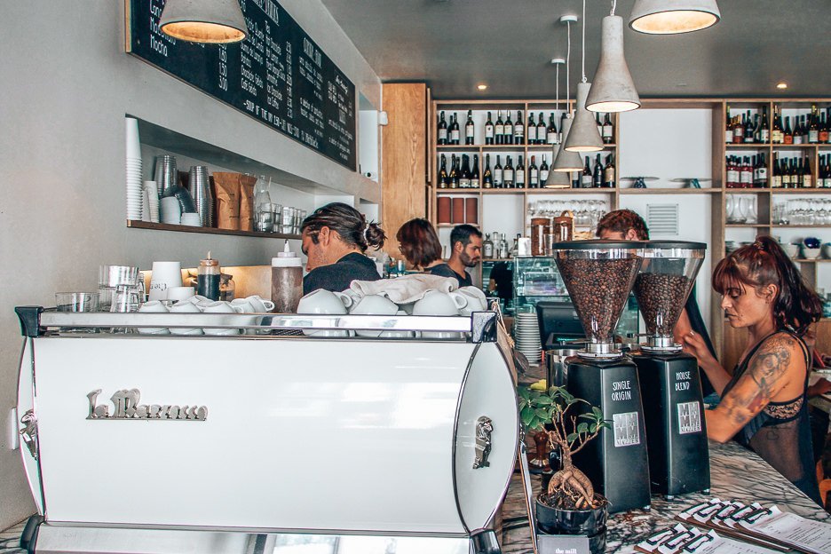 Baristas and wait staff work hard behind the coffee counter at the Mill cafe in Lisbon, Portugal