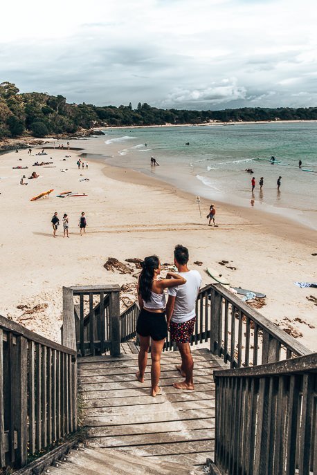 The Ultimate Byron Bay Travel Guide 2 P A couple watch swimmers and surfers from the Pass in Byron Bay