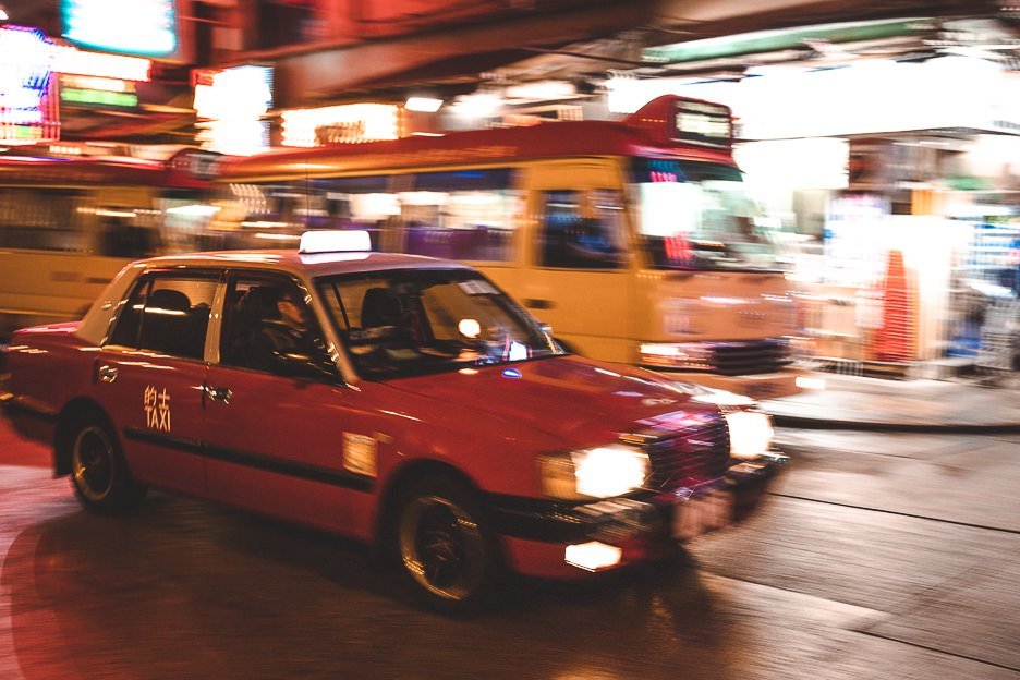 The blur of a red taxi driving by at night in Mong Kok, Hong Kong - shot with Canon EF 50mm lens