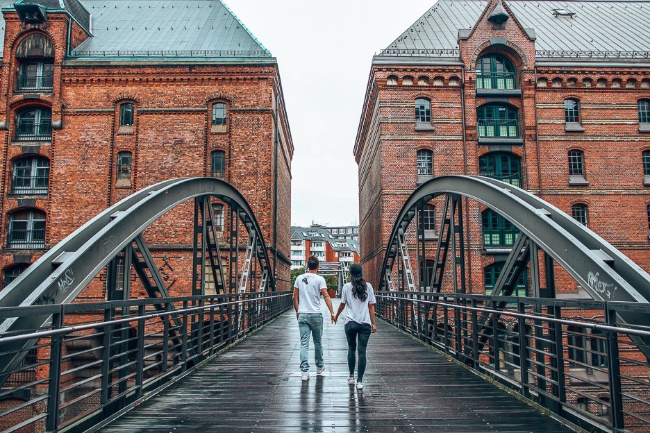 A couple walk over one of the bridges in Speicherstadt, Hamburg, Germany