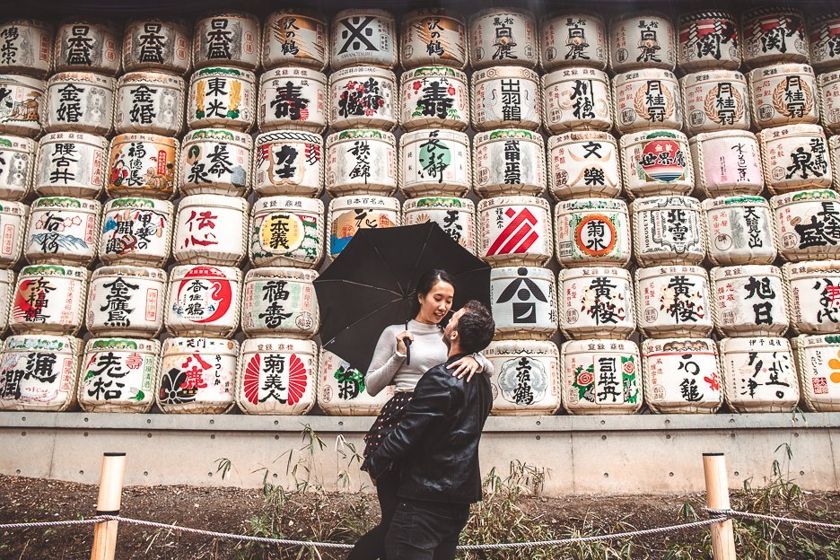 A couple in front of the sake barrels at Meiji Shrine, Tokyo