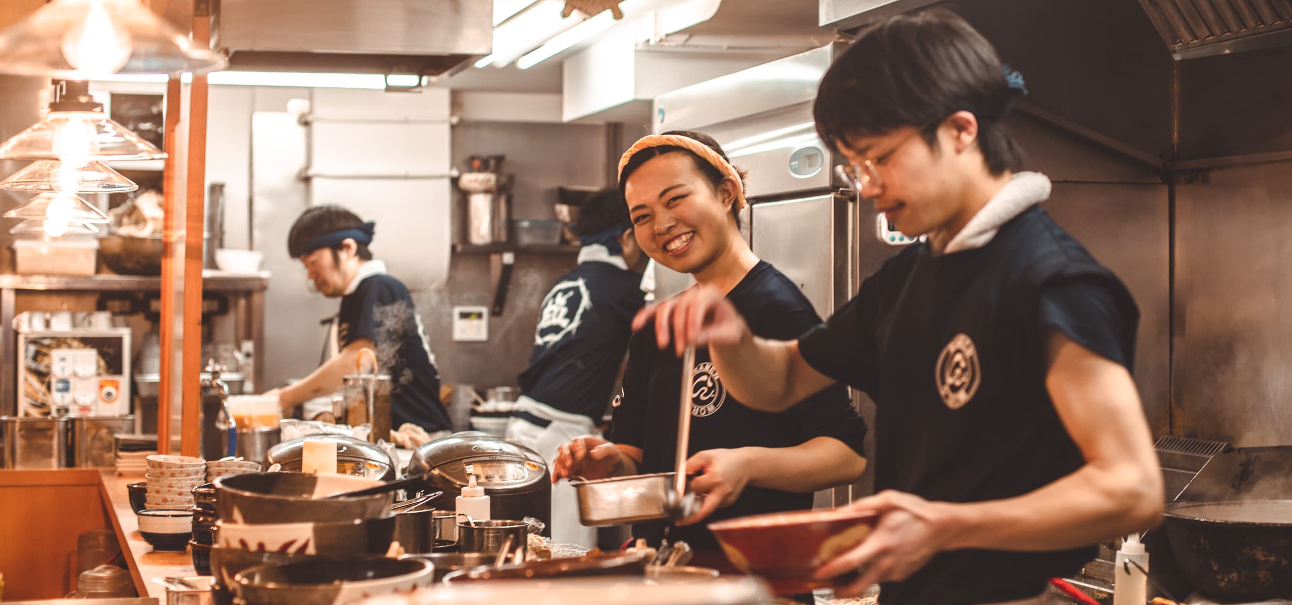Chefs in the kitchen making ramen in Tokyo, Japan