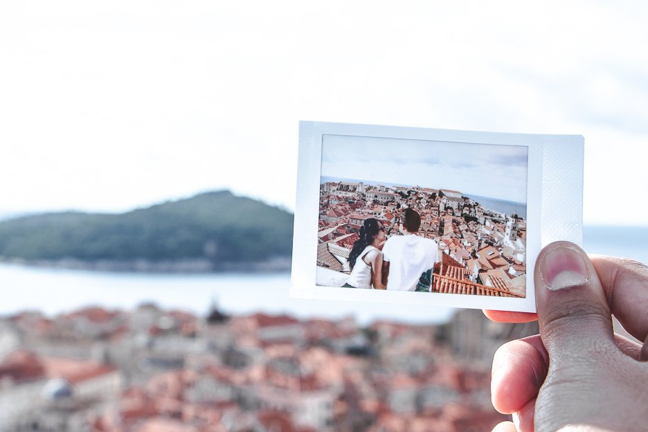 A polaroid shot of a couple overlooking Dubrovnik Old Town