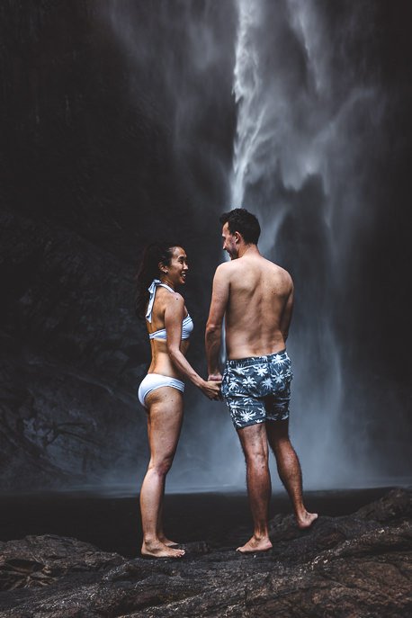 Couple standing at bottom of Wallaman Falls, Queensland