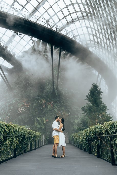 A couple kissing underneath the mist in the Cloud Forest, Gardens By The Bay Singapore