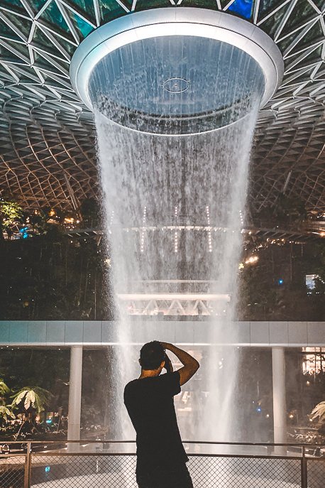 Snapping a photo of the waterfall at Jewel Changi Airport in the evening