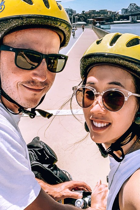 16 Ideas For Your Next Brisbane Staycation 1 P A selfie of the Travel Quandary riding City Cycle bicycles
