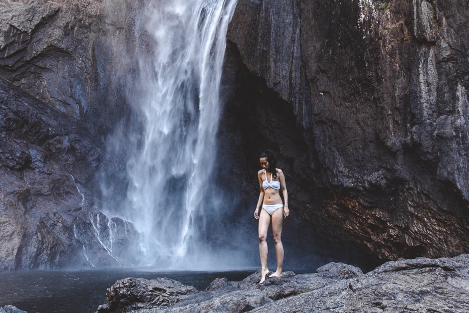 How To Get To Wallaman Falls | A girl in a white bikini standing at the bottom of Wallaman Falls