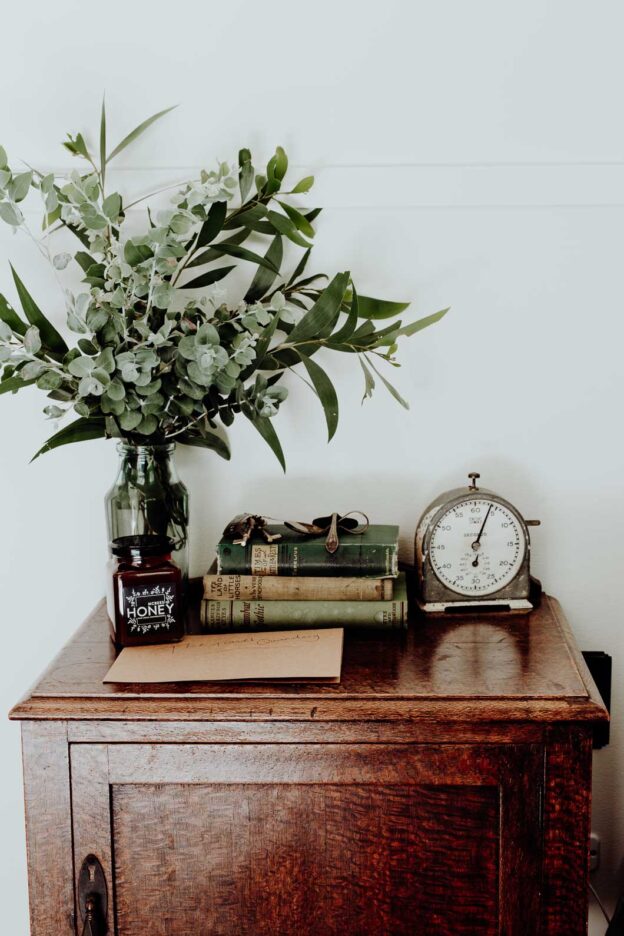 Antique adornments and fresh garden flowers on the bedside table at Palmer & Gunn