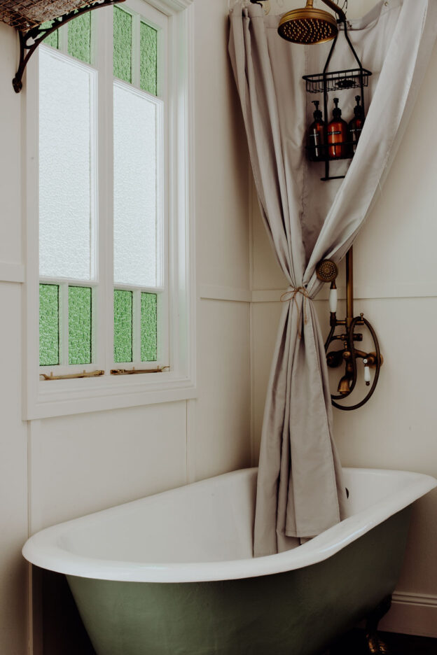 Vintage bathtub and glass windows inside the wee tiny Palmer & Gunn