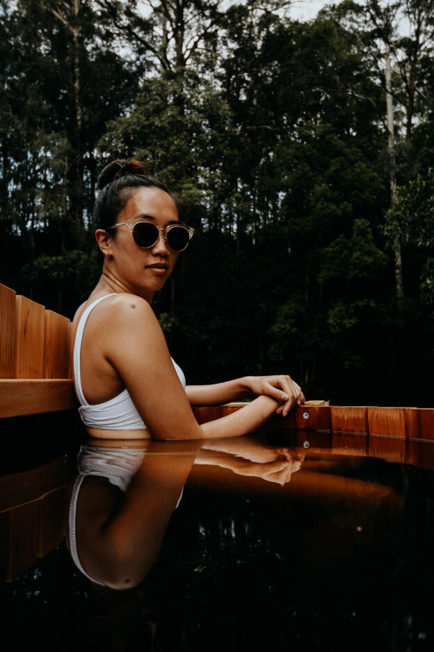 A woman soaks in the warm water of the cedar wood hot tub, Palmer & Gunn
