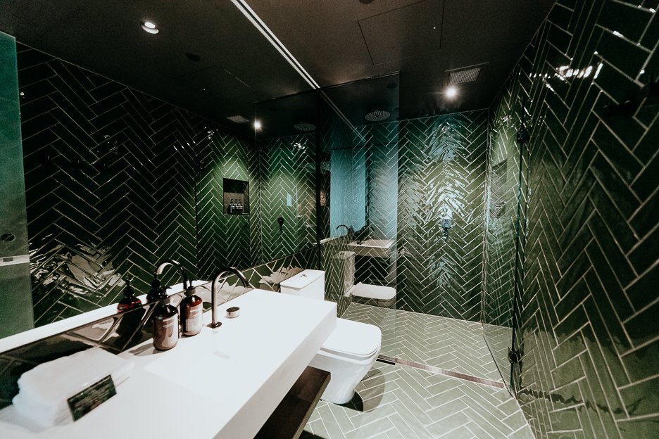 Green tiles inside bathroom of Grove Room 25