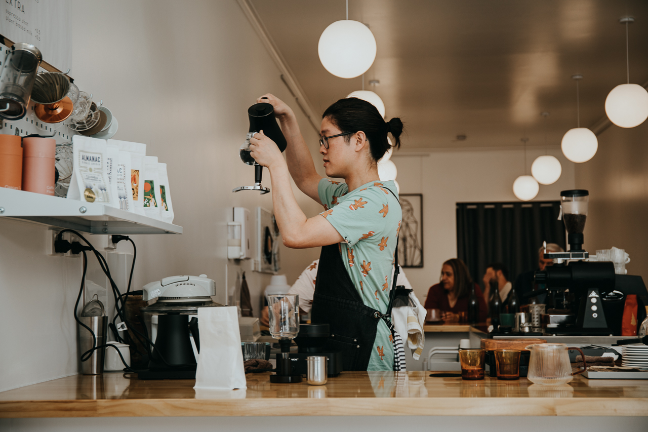 Brian concentrates on pouring the perfect brew behind the counter at Somewhere Coffee Bar, Hobart, Tasmania