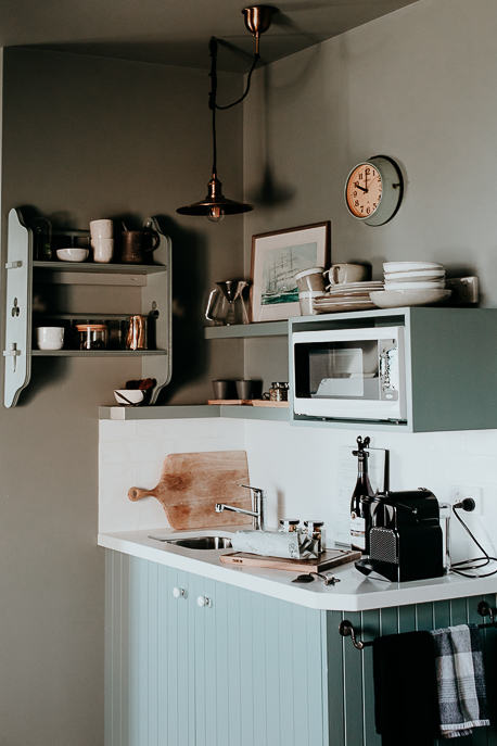 Fully stocked kitchenette with coffee machine, microwave and vintage trinkets inside the Greenhills Suite, The Ship Inn Stanley. Tasmania, Australia
