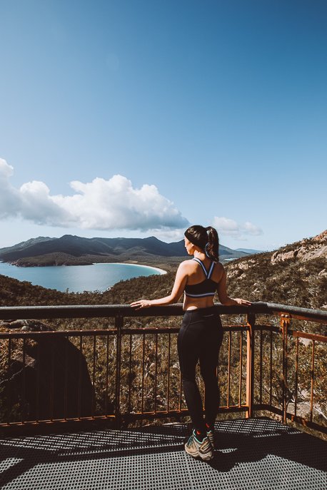 Tasmania Itinerary 3.1 P Standing at Wineglass Bay Lookout overlooking Wineglass Beach | Tasmanian Road Trip